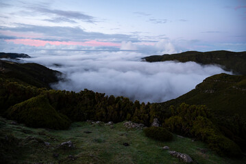 Panoramic view over the cloud-filled Ribeira da Janela valley at dusk, near Rabaçal Nature Reserve, Madeira