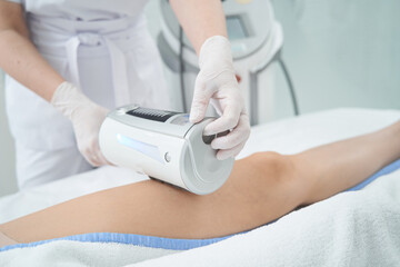 Person conducting therapy on patient leg