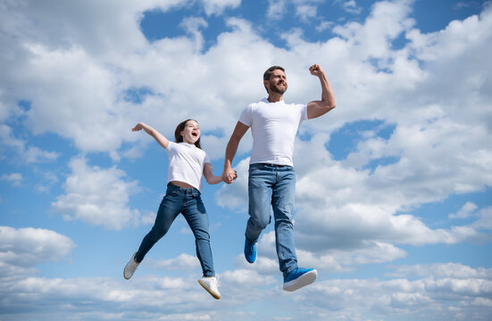 happy father and daughter jump in sky. freedom