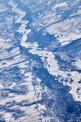 Mountain landscape with river, view from an airplane, Snowy panorama