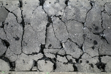 Texture of broken asphalt of a road
