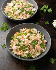 Salmon Couscous salad with feta cheese dressing and herbs. healthy food.