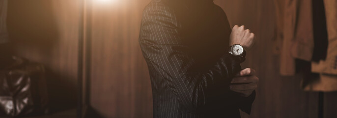 Businessman checking time from watch