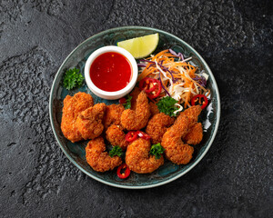 Crispy Prawns in breadcrumbs. Served with cabbage, carrot salad and soy and sweet chilli sauce