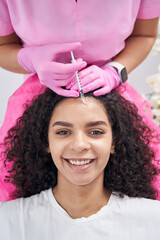 Beautician performing minimally invasive injections for facial mesotherapy