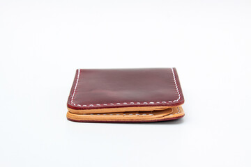 Red or Maroon natural leather wallet isolated on a white background. Closeup expensive wallet. Leather craft. Homemade.