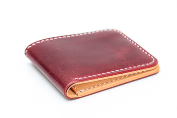 Red or Maroon natural leather wallet isolated on a white background. Closeup expensive wallet. Leather craft. Homemade.