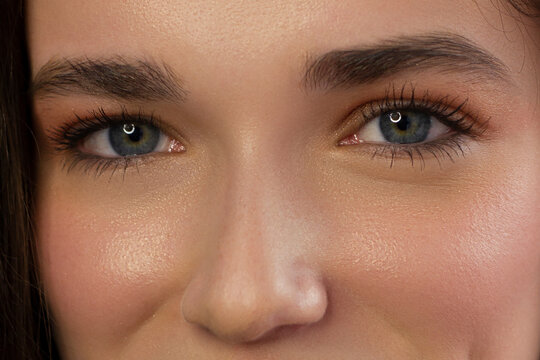 Macro shot of woman's beautiful eye with extremely long eyelashes. Sexy view, sensual look. Female eye with long eyelashes