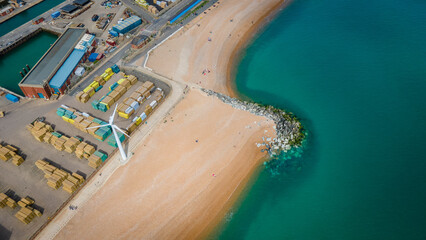 Beach by industrial estate in Brightonand Hove on a clear sunny day