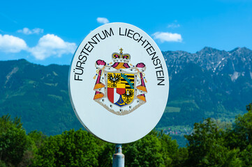 Eschen, Liechtenstein - May 20,2022: Border sign on the bridge over the river Rhein with the inscription Principality of Liechtenstein and the coat of arms of the princely state