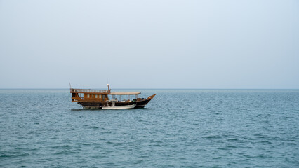 Lonely traditional Dhow boats in qatar sea.