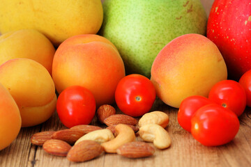 Healthy nuts and fruits on wood background