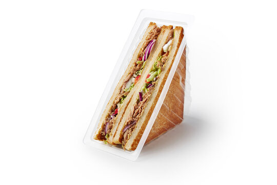 Pair of fresh tuna sandwiches in food container on white
