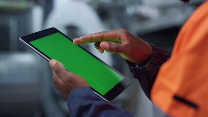 Greenscreen tablet engineer hands at plant closeup. Man surfing mockup screen