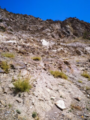 hiking in the mountains on the blue sky background