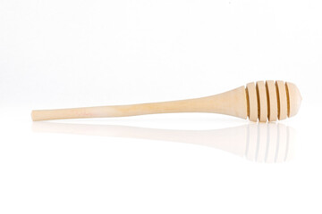 Single wooden for honey spoon on white background, honey stick isolated, Wooden spoon for honey. Close-up