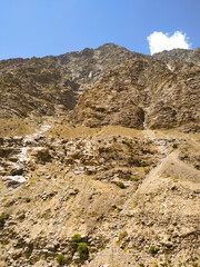 Landscape in the mountains on blue sky with clouds