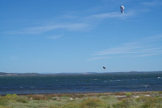 Surfer flying under a perfect sky