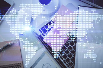 Business theme hologram drawings over computer on the desktop background. Top view. Multi exposure. Concept of international connections.