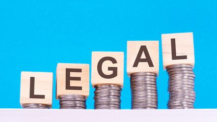 Legal - text on wood cube block stack with coins