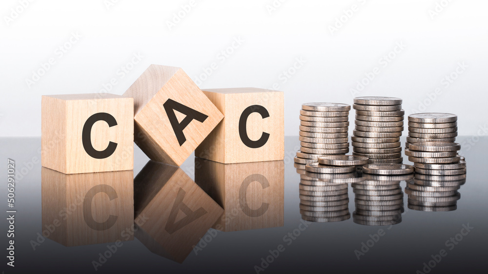 Poster cac - text is made up of letters on wooden cubes lying on a mirror surface