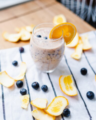 Orange and bluberry smoothie in a glass on the table, diet, healthy lifestyle, food
