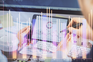 Double exposure of man's hands holding and using a phone and financial chart drawing. Market analysis concept.