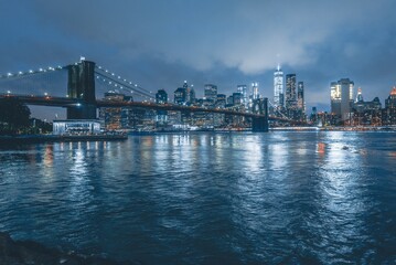 Fototapeta na wymiar Brooklyn Bridge at Night with Water Reflection in New York City