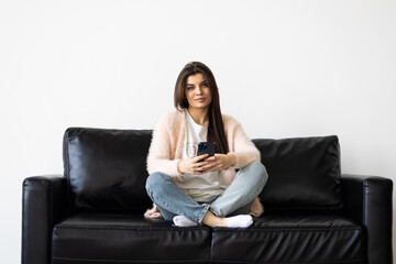 Fototapeta na wymiar Portrait beautiful young woman use smart mobile phone on sofa in living room interior