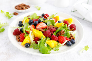 Fruit and berry salad with strawberry, blueberry, raspberry, mango and pecan nuts. Healthy food, diet