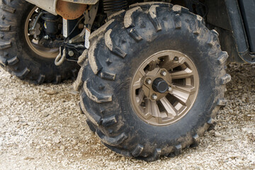 Fototapeta na wymiar dirty ATV wheel in parking lot