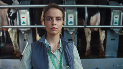 Livestock farmer posing milking facility portrait. Dairy products manufacture.