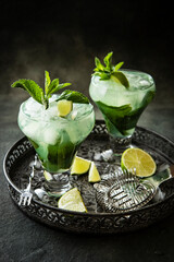 Citrus lime  fruit cocktail with   mint in glass, selective focus