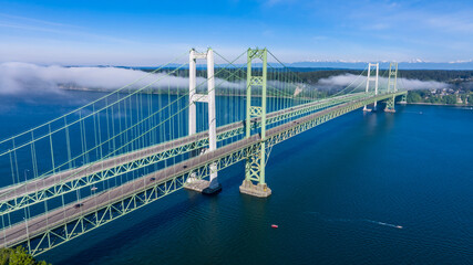 Aerial view of the Narrows bridge in Tacoma Washington with clouds drifting in