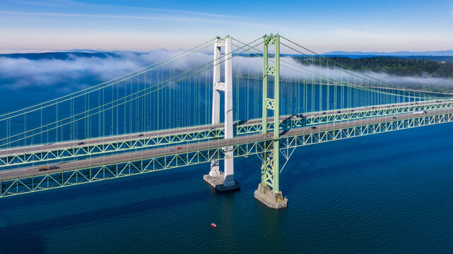 Aerial view of the Narrows bridge in Tacoma Washington with clouds drifting in