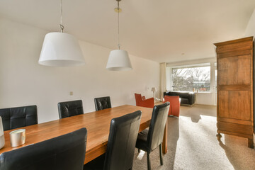 Interior of dining area and living room with couch near big windows