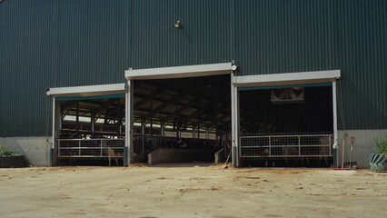 Dairy farm worker walking out modern manufacture facility at countryside alone.