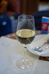 Lifestyle of beautiful Vienna, glass of white dry Austrian wine served in old Viennese-style cafe in Vienna, Austria