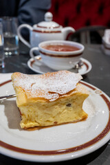 Austrian sweet dessert, filled with white cheese strudel served warm in traditional cafe in Vienna, Austria with cup of black tea