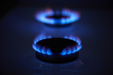 Blue propane gas flame. Burning gas. Kitchen stove burner. Natural gas market concept image with...
