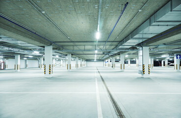 Horizontal image of clean white underground parking lot - obrazy, fototapety, plakaty