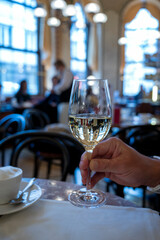Lifestyle of beautiful Vienna, glass of white dry Austrian wine served in old Viennese-style cafe in Vienna, Austria
