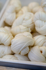 White soft braid cheese on market display