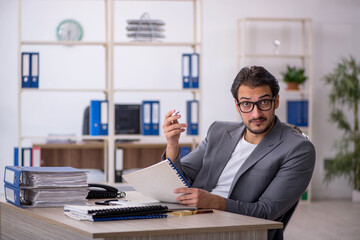 Young male employee working in the office