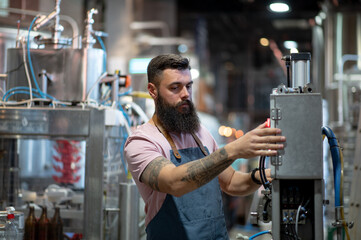 Portrait of a bearded man working in a brewery