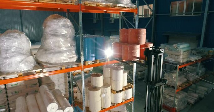 Warehouse at the nonwovens factory. Flight to the warehouse of non-woven fabrics. Large modern warehouse with synthetic winterizer rolls