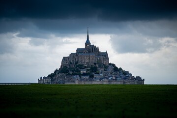 The Mont Saint-Michel tidal island in beautiful twilight during a storm, Normandy, France