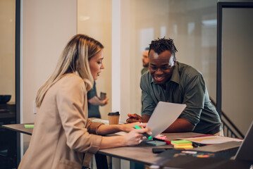 Two multiracial business colleagues working together in the office