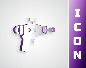 Paper cut Ray gun icon isolated on grey background. Laser weapon. Space blaster. Paper art style. Vector