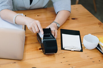 card swipe machine, cyber security, convenience of payment, staff use EDC card machine to swipe customer credit card to make in-store purchases